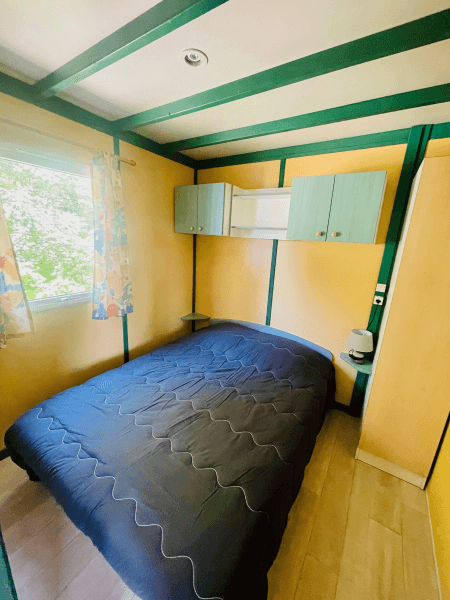 Chambre avec lit double des chalets Pommier 4 personnes climatisés. Locations de chalets à Camon