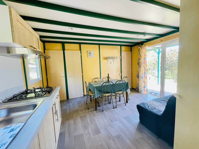 Kitchen/living area with sofa. Chalet rentals in Ariège, comfort Epicéa chalets for 6 people